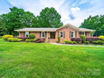 Charming brick home with well-manicured landscaping and a lush green lawn at 3313 Lancaster Hwy, Monroe, NC 28112