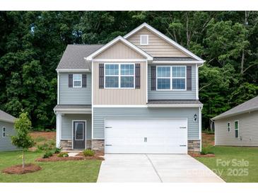 Charming two-story home with blue siding, white garage door, and a well-manicured front lawn at 3339 Burberry Dr, Gastonia, NC 28052