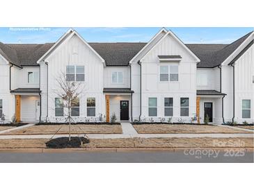 Beautiful, modern townhome exterior with white siding, a black door, and professionally landscaped front yard at 356 Bly St, Rock Hill, SC 29732