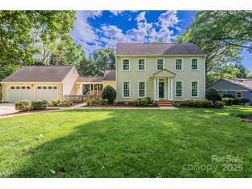 Charming two-story home with an attached two-car garage and a lush green front lawn at 4501 Bainview Dr, Mint Hill, NC 28227