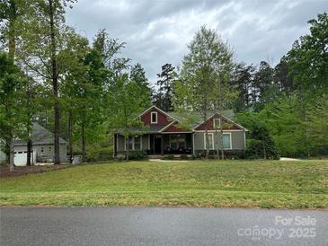 Charming single-story home featuring a landscaped yard, mature trees, and inviting curb appeal at 4561 N Wynswept N Dr, Maiden, NC 28650