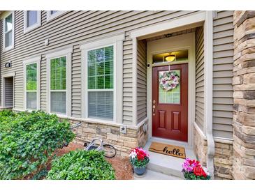 Inviting front entrance with a charming wreath and colorful flower pots at 6842 Berewick Commons Pkwy, Charlotte, NC 28278