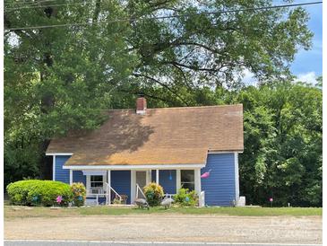 Charming blue single story home with front porch and decorative yard at 745 Old Charlotte Sw Rd, Concord, NC 28027