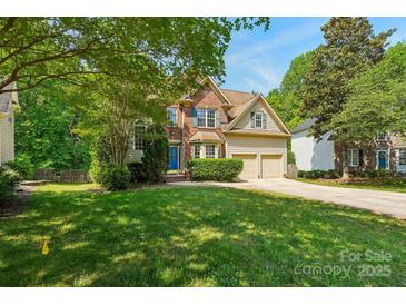 Charming two-story home with a brick facade, well-maintained lawn, and a two-car garage in a landscaped neighborhood at 10316 Willingham Rd, Huntersville, NC 28078