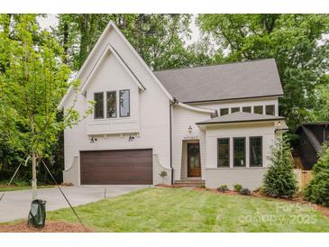 Beautiful two-story home featuring a modern design, attached garage, and professionally landscaped front yard at 1807 Arnold Dr, Charlotte, NC 28205