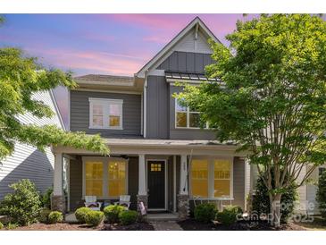 Charming two-story home featuring a welcoming front porch, landscaped yard, and elegant gray siding at 209 Helton Ln, Fort Mill, SC 29708