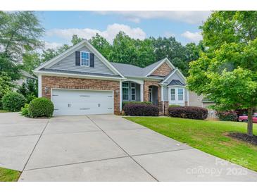 Charming home featuring a stone and siding facade, well-manicured lawn, and a two-car garage at 968 Autumn Glen Ct, Clover, SC 29710