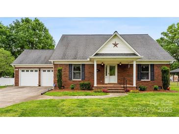 Charming single-story brick home with a well-manicured lawn and two-car garage at 102 Sussex Ave, Cherryville, NC 28021