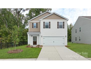 Charming two-story home features a well-manicured lawn and attached two car garage at 414 Janie Nw Cir, Newton, NC 28658