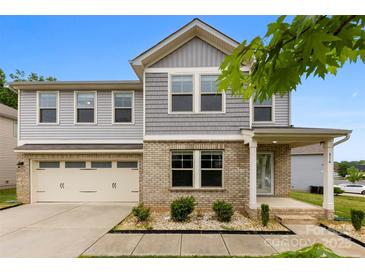 Charming two-story home featuring a brick facade, attached garage, and well-manicured landscaping at 614 Oldham Ln, Rock Hill, SC 29732