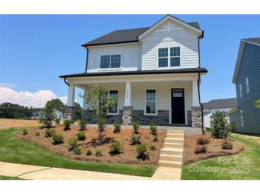 Charming two-story home features a landscaped yard, stone accents, and a welcoming front porch at 9612 Pointer Rd # 59, Huntersville, NC 28078