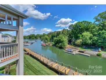 Picturesque waterfront view with docks and lush greenery under a sunny sky at 104 Pier 33 Dr # 312, Mooresville, NC 28117