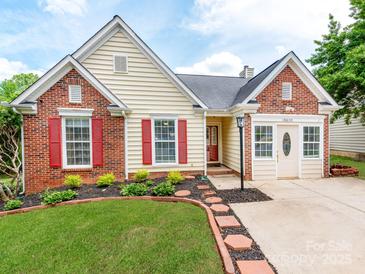 Charming single-Gathering home with a brick and vinyl facade, red shutters, and a well-manicured lawn at 10408 Milstead Ct, Charlotte, NC 28215
