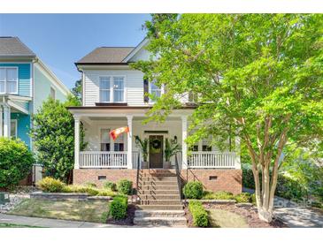 Charming two-story home featuring a welcoming front porch and well-manicured landscaping at 117 Mills Ln, Fort Mill, SC 29708