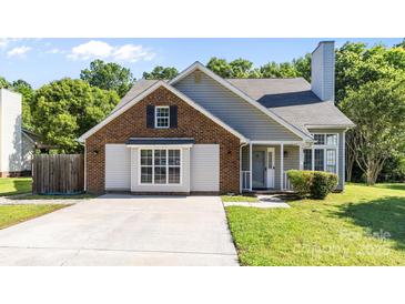 Charming single Gathering home with brick and gray siding, a concrete driveway, and well-maintained landscaping at 13914 Loch Loyal Dr, Charlotte, NC 28273