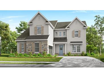 Charming two-story home featuring stone accents, shutters, and a welcoming blue front door at 15743 Sweet Virginia Ln, Huntersville, NC 28078
