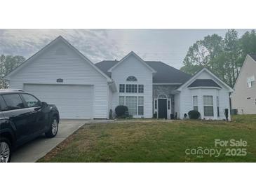 Charming one-story home featuring white siding, a two-car garage, and a stone-accented entryway at 1579 Matthews Dr, Rock Hill, SC 29732