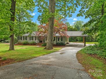 Charming one-story home with well-maintained lawn, covered parking, and mature trees offering shade at 981 Meadowlark Dr, Rock Hill, SC 29732
