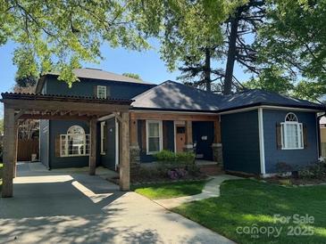 Charming two-story home featuring a cozy front porch and covered parking at 1019 Valley St, Kannapolis, NC 28081