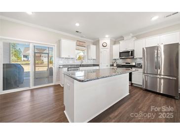 Eat-in kitchen showcasing a stainless steel fridge, granite countertops and a large center island at 11249 Island View Ln, Lancaster, SC 29720