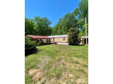Charming single-story home with red-roofed carport and lush green lawn at 143 Greenville Blvd, Bessemer City, NC 28016