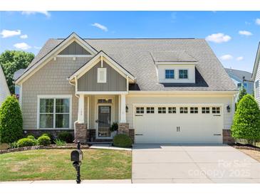 Charming home with a manicured lawn, complemented by a two-car garage and inviting front porch at 199 Blossom Ridge Dr, Mooresville, NC 28117