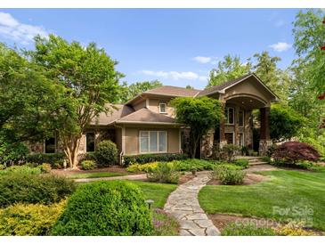 Charming home featuring stone accents, lush landscaping, and a manicured lawn at 2915 Cutter Ct, Waxhaw, NC 28173