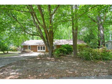 Charming brick home nestled among mature trees with a spacious front yard at 316 Anne Ave, Waxhaw, NC 28173
