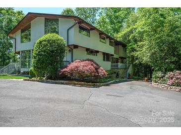 Stunning two-story home featuring unique architectural details and beautifully landscaped front yard at 3165 Laurel Ridge Nw Rd, Hickory, NC 28601