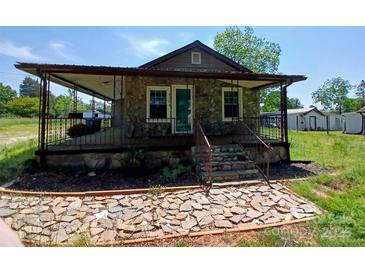 Charming stone cottage with a covered porch and decorative stone walkway at 4194 Buffalo Shoals Rd, Maiden, NC 28650