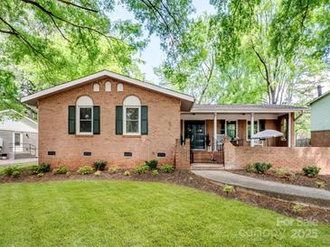 Charming brick home featuring a well-maintained lawn, mature trees, and lovely curb appeal at 500 Colony Acres Dr, Charlotte, NC 28217