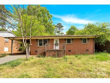 Charming single-story brick home with a cozy front porch and a well-maintained yard at 735 Wilbrown Cir, Charlotte, NC 28217