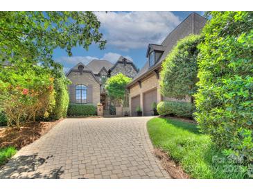 Charming brick home with a three-car garage and a patterned brick driveway at 809 Verney Ln, Charlotte, NC 28226