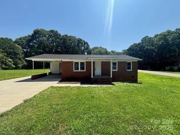 Charming single-story brick home with a well-manicured lawn and a convenient carport at 907 Mcgowan Rd, Shelby, NC 28150