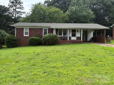 Charming single-story brick home featuring a welcoming front porch and lush green lawn at 908 Mcgowan Rd, Shelby, NC 28150