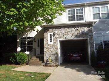 Charming home featuring stone accents, attached garage, and landscaped front yard at 1502 Mulberry Ridge Dr # 1, Newton, NC 28658