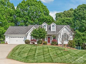 Charming two-story home with a well-manicured lawn, attached garage, and vibrant landscaping, creating a welcoming curb appeal at 1542 Crowders Woods Dr, Gastonia, NC 28052