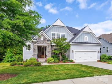 Charming home with stone accents, manicured lawn, and an attached two-car garage at 5420 Meadowcroft Way, Fort Mill, SC 29708