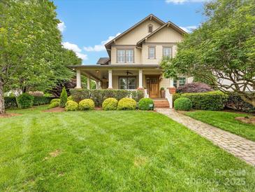 Charming two-story home with a inviting front porch, lush landscaping, and a well-manicured lawn at 601 Dorothy Dr, Charlotte, NC 28203