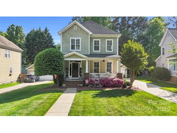 Charming two-story home with a welcoming front porch and beautifully landscaped front yard, offering curb appeal at 7814 Knox Ridge Rd, Huntersville, NC 28078