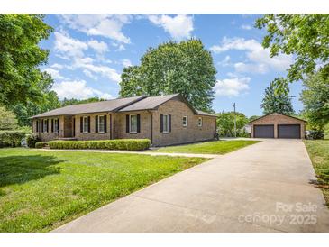 Charming brick ranch home with a well-manicured lawn and a two car detached garage at 174 Wintergreen Cir, Statesville, NC 28677