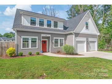Charming home featuring a red door, two-car garage, and well-maintained landscaping at 1832 Montclair Ave, Gastonia, NC 28054
