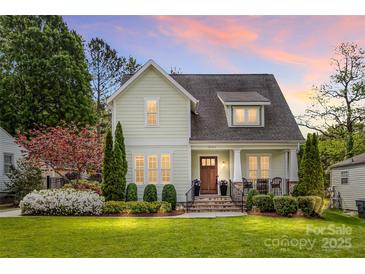 Charming home with manicured lawn, lush landscaping, and a welcoming front porch at sunset at 3101 Auburn Ave, Charlotte, NC 28209