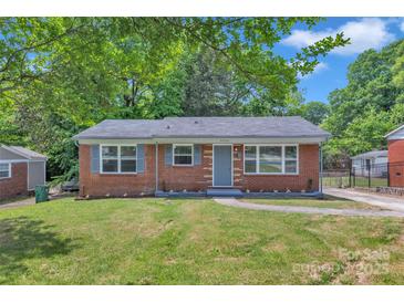 Charming brick home featuring a well-manicured front yard and a cozy entrance walkway at 4553 Morgan St, Charlotte, NC 28208