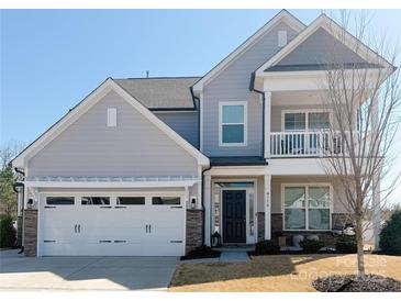 Charming two-story home featuring light gray siding, a two-car garage, and inviting front porch at 6176 Russo Ct, Lancaster, SC 29720