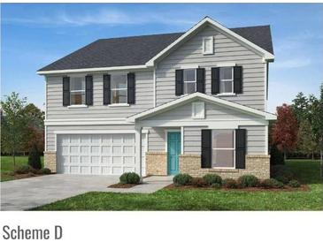 Charming two-story home with gray siding, a two-car garage, and a well-manicured front lawn at 6888 Wilson Creek Dr, Indian Land, SC 29707