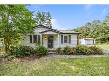 Charming home featuring a cozy entrance, landscaped garden, and well-maintained front yard at 804 Allen Dr, Marshville, NC 28103