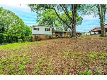 Charming split-level home with brick and siding exterior, mature trees, and a covered parking area at 1521 19Th Sw St, Hickory, NC 28602