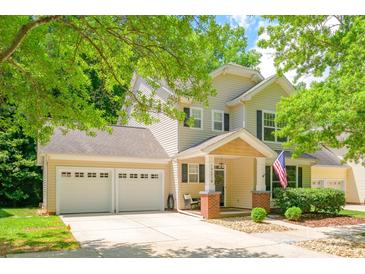 Charming two-story home featuring a welcoming front porch and attached two-car garage at 17219 Grand Central Way, Cornelius, NC 28031