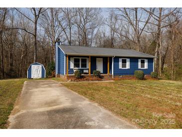 Charming blue house with a shed and long driveway in a wooded neighborhood at 1757 Ashcroft Ln, Rock Hill, SC 29732
